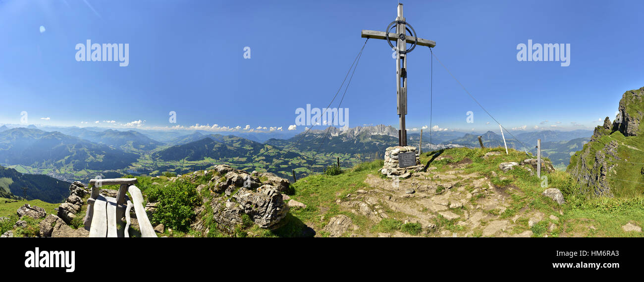 mountainpeak in front of the Kitzbüheler Horn (mountain) with summit cross Stock Photo