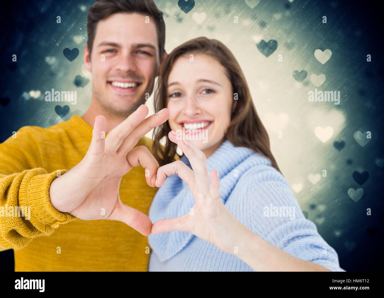 Composite image of couple forming heart shape with hands Stock Photo ...