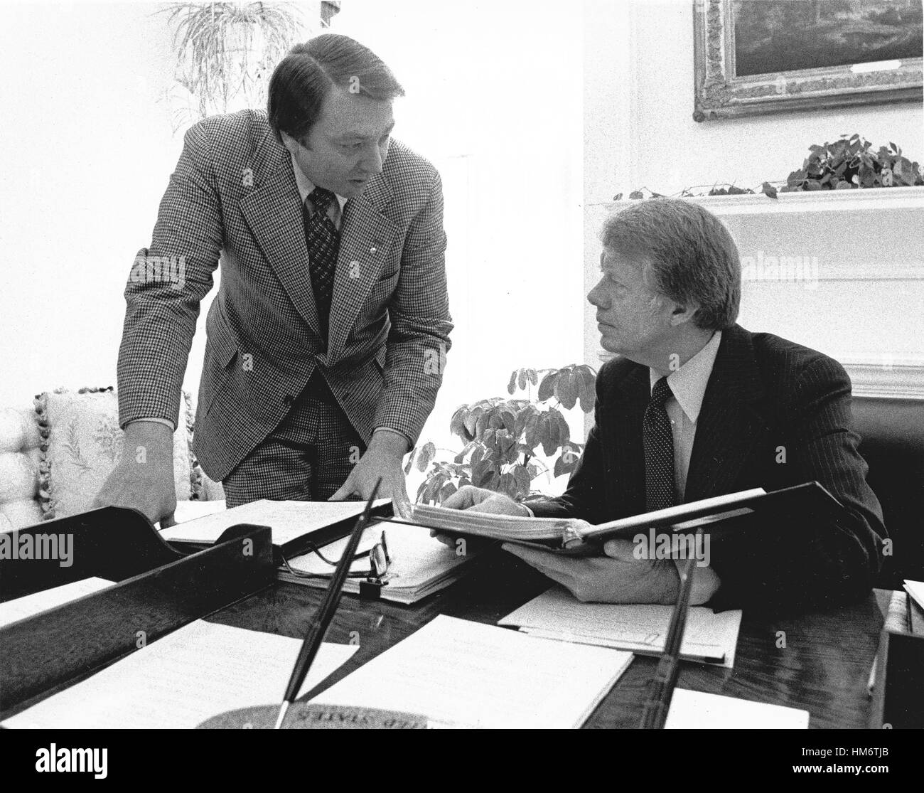 United States President Jimmy Carter, right, meets with his Assistant for Congressional Liaison, Frank Moore, left, in the Oval Office of the White House in Washington, DC on February 9, 1977. Stock Photo