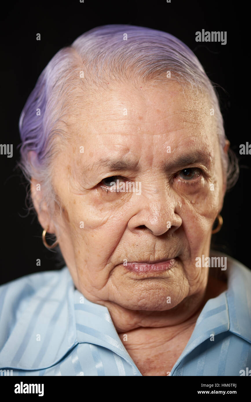 portrait of wrinkled grandma isolated on black background Stock Photo