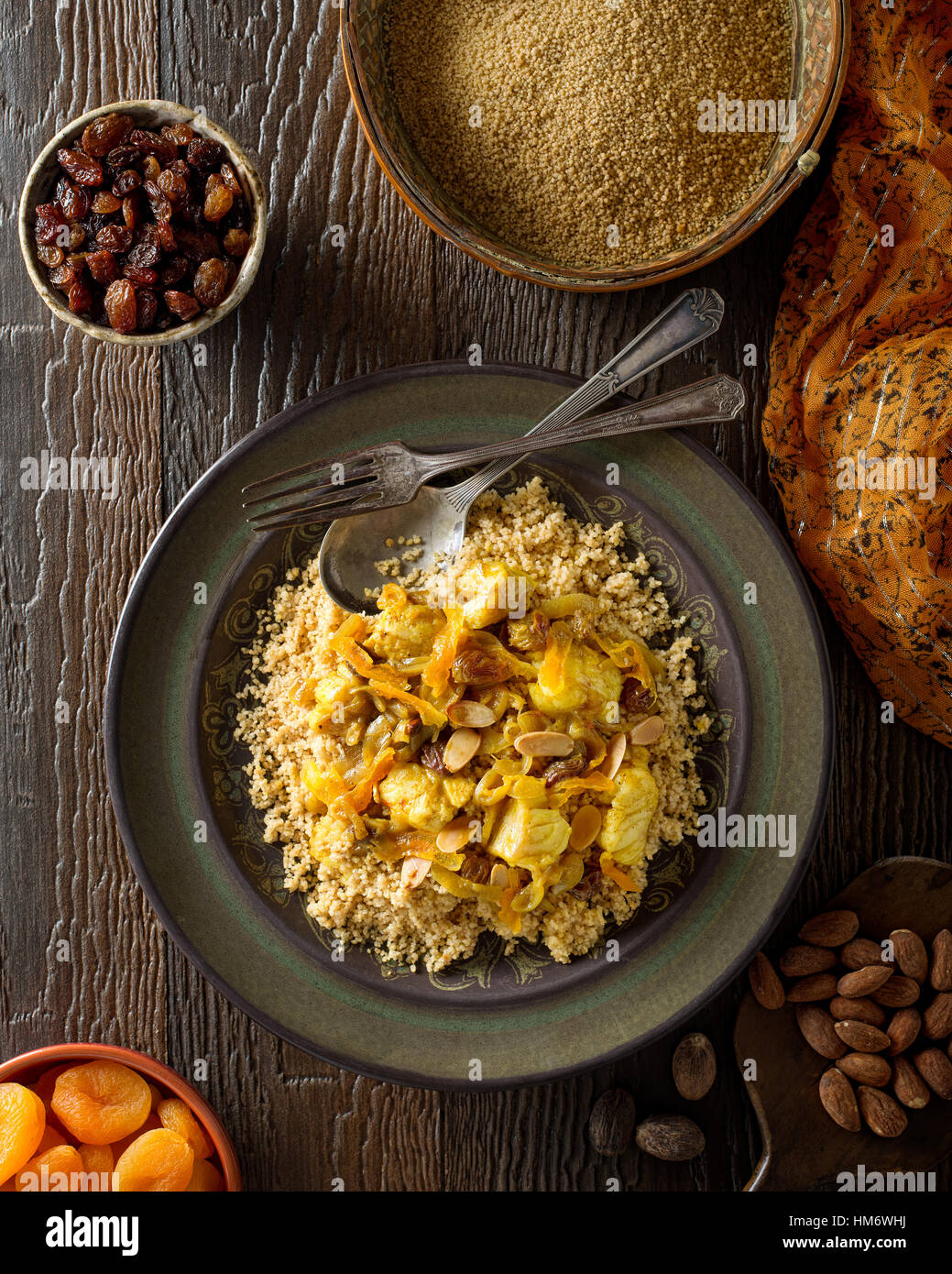 Delicious homemade Tunisian style couscous with fish, raisins, apricots, and toasted almond. Stock Photo