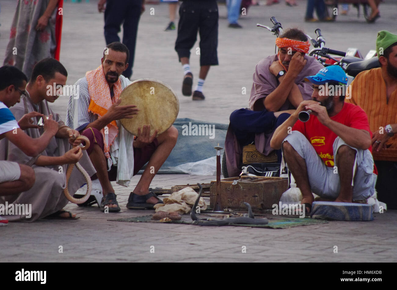 MARRAKECH,MA - CIRCA JULY, 2013 - Snake charnmers entertain tourists in Marrakech main square, Jemaa el Fna. Stock Photo