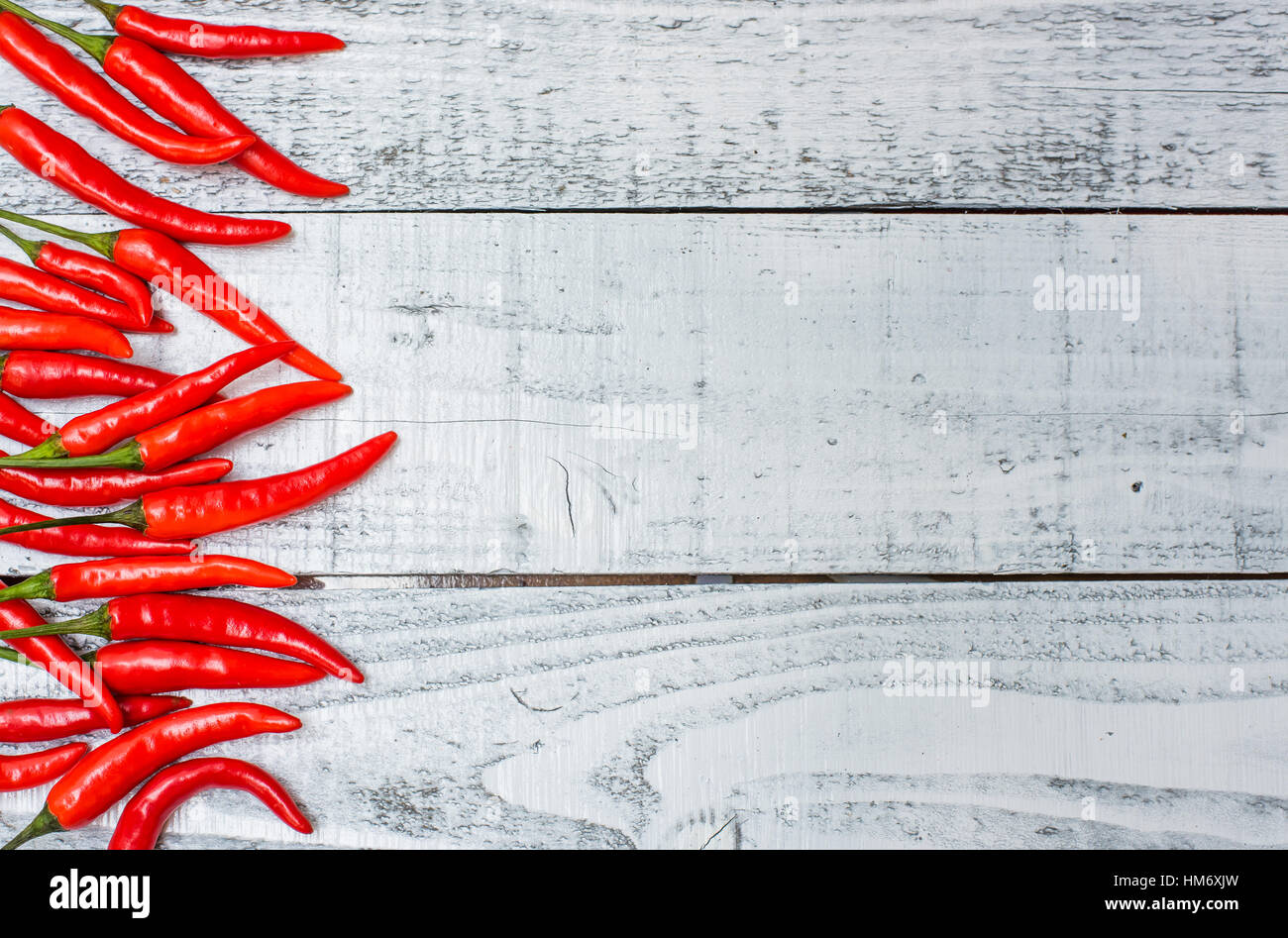 Hot and spicy red chilli on wood table background Stock Photo - Alamy