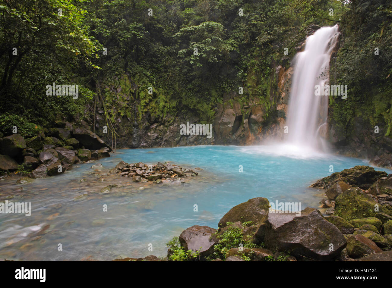 Rio Celeste (Blue River) waterfall in Tenorio Volcano National Park, Costa Rica.  The blue coloration is a result of sulphur from the volcano seeping  Stock Photo