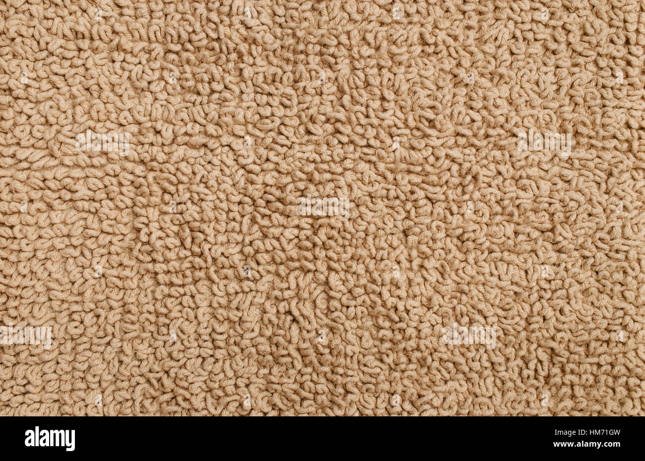 Texture of a fleecy carpet of beige color. The seamless background Stock Photo