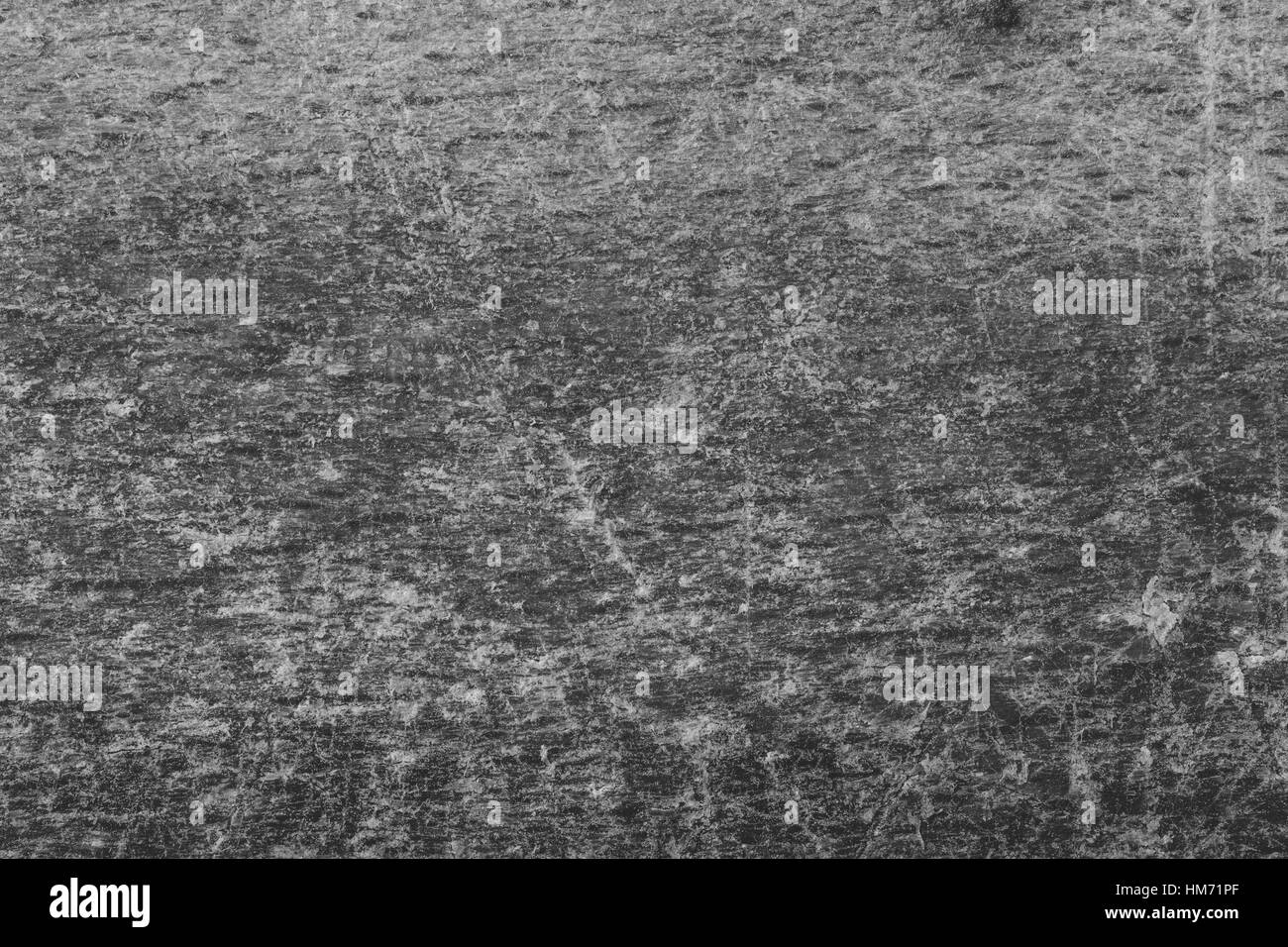 Grunge surface with grain and scratches in black and white with place for text. Stock Photo
