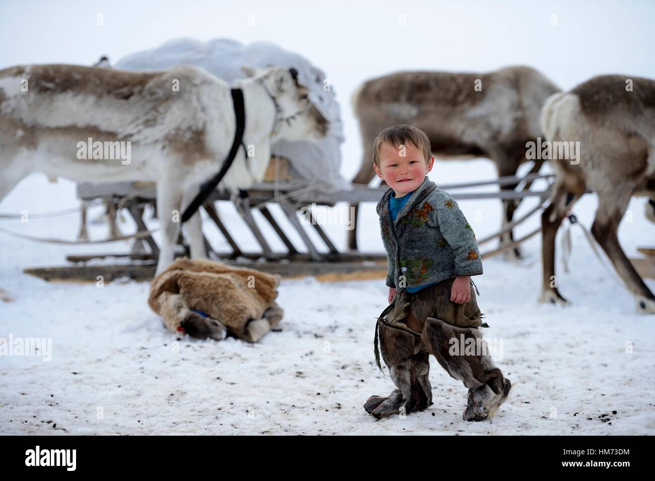 Young Nenets boy at camp wearing the traditional winter boots made with  reindeer skin / fur, Yar-Sale district. Yamal, Northwest Siberia, Russia  Stock Photo - Alamy