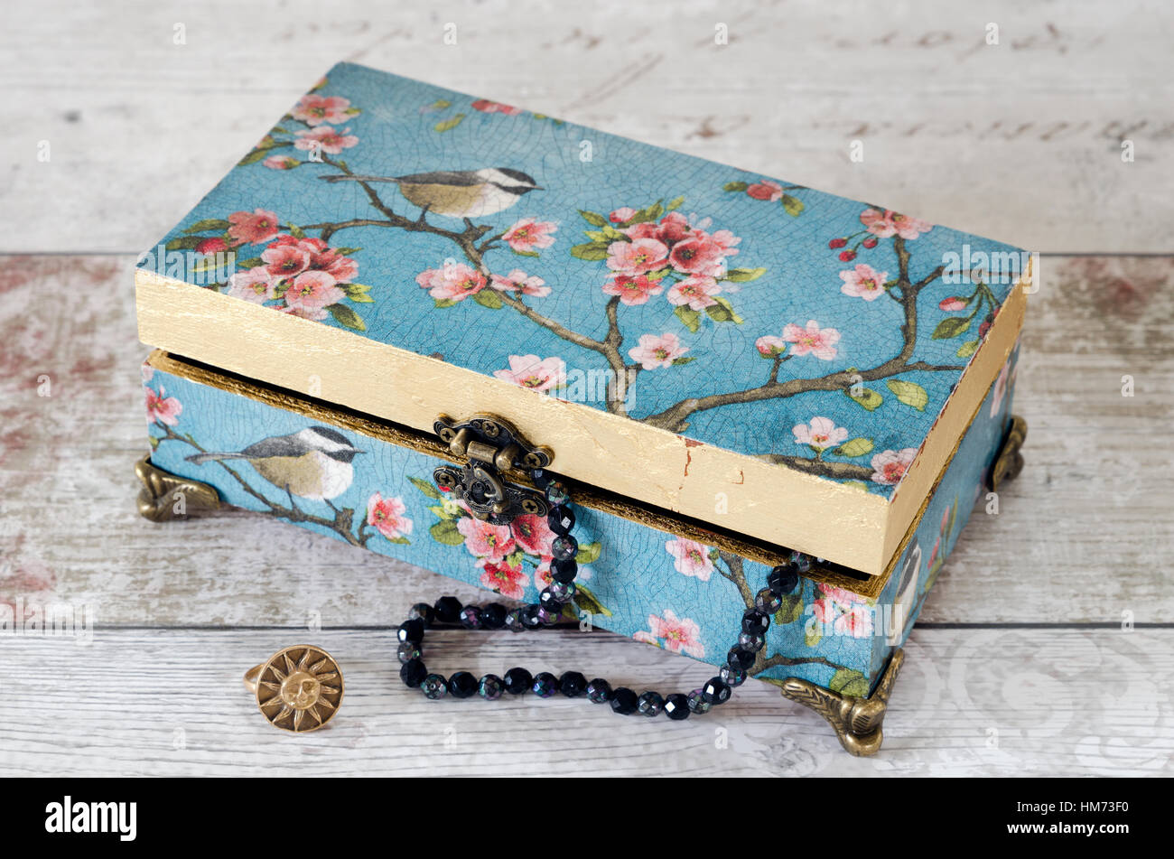 A handmade jewellery box decoupaged with vintage papers and gilded with  gold leaf Stock Photo - Alamy