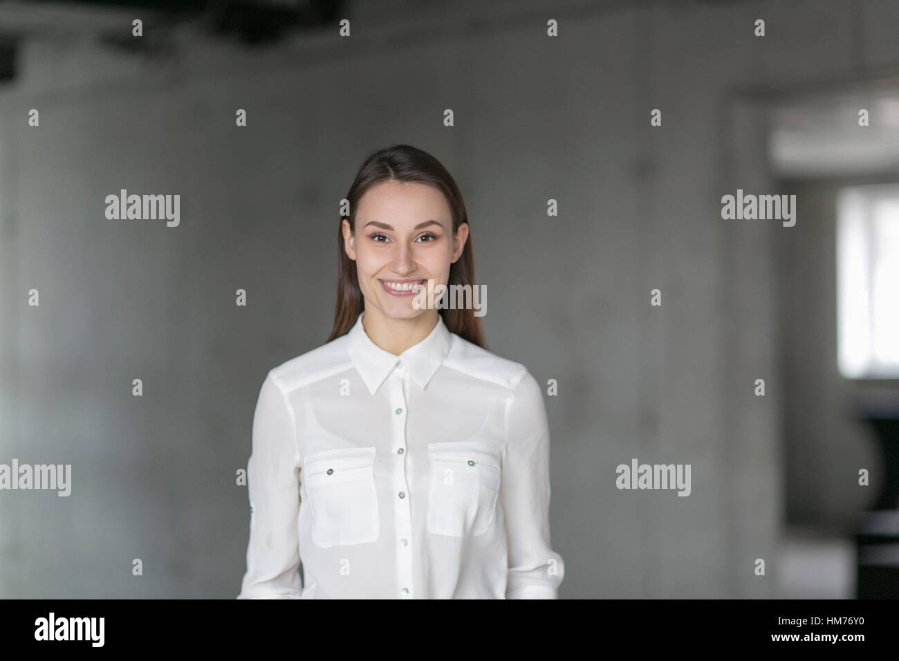 Portrait Of A Pretty Woman In The Office Looking At Camera Stock Photo Alamy