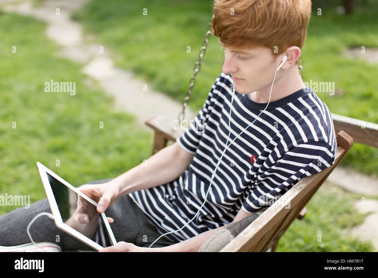 Boy using an i pad Stock Photo - Alamy