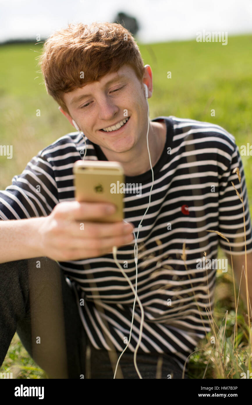 Boy having video chat on iphone Stock Photo