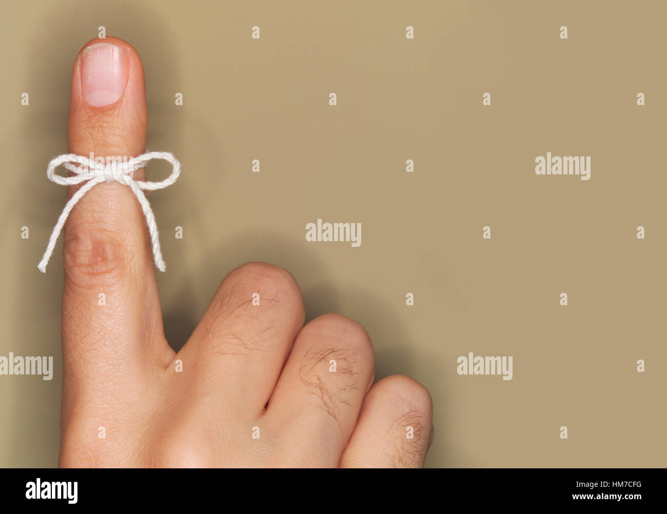 String bow tied on finger Stock Photo Alamy