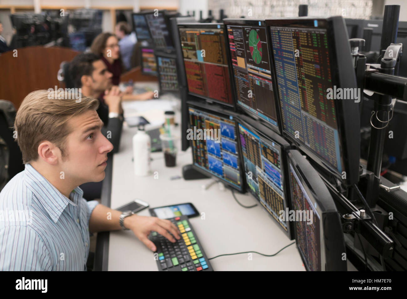Young traders analyzing computer data Stock Photo - Alamy