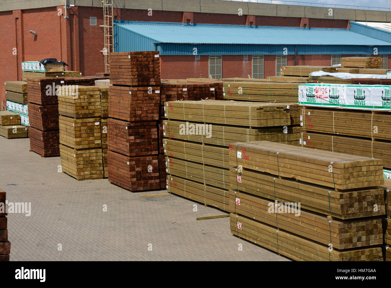 Stacks of imported timber on dockside at Shoreham Harbour in West ...