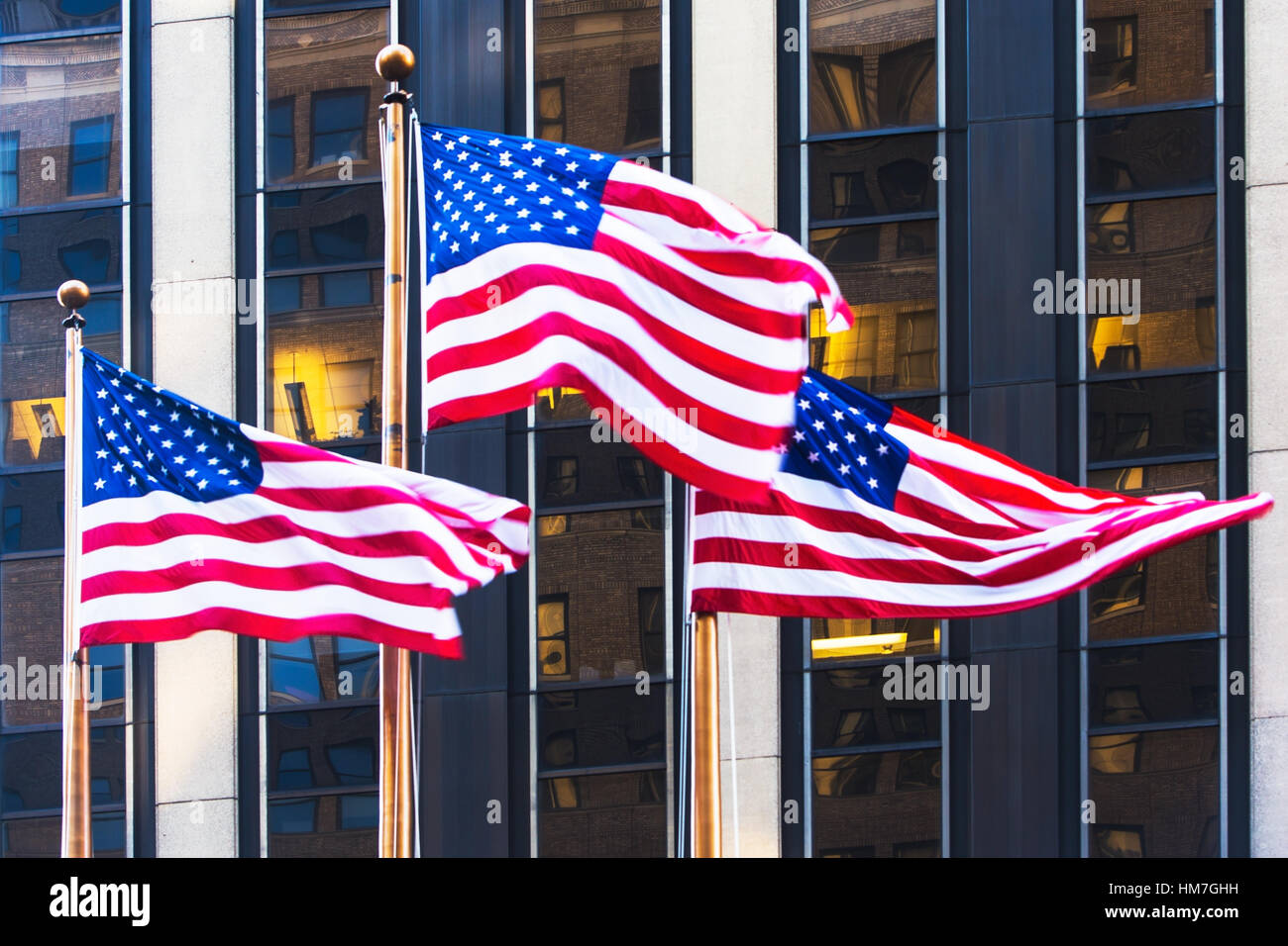 USA, New York, American flags in front of office building Stock Photo