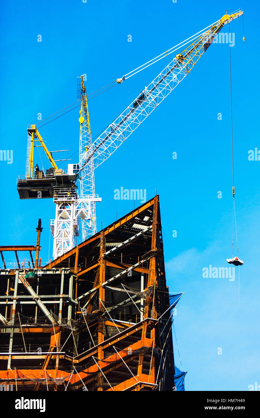 Crane at construction site against clear sky Stock Photo