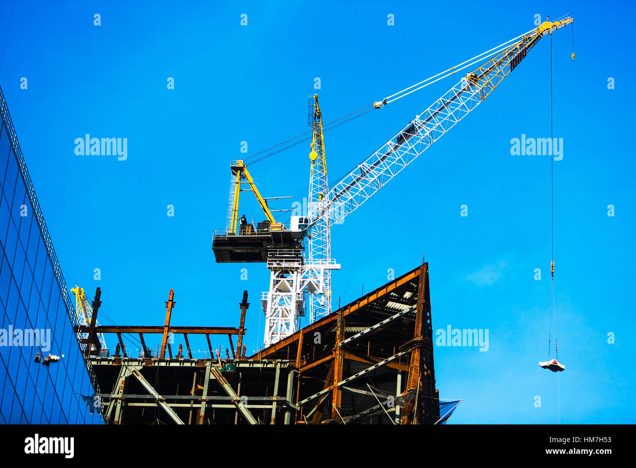 Crane at construction site against clear sky Stock Photo