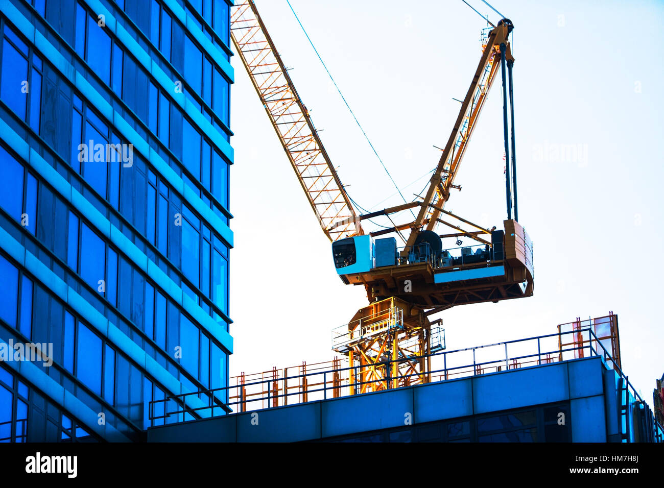 USA, New York, New York City, Crane with office building in foreground Stock Photo
