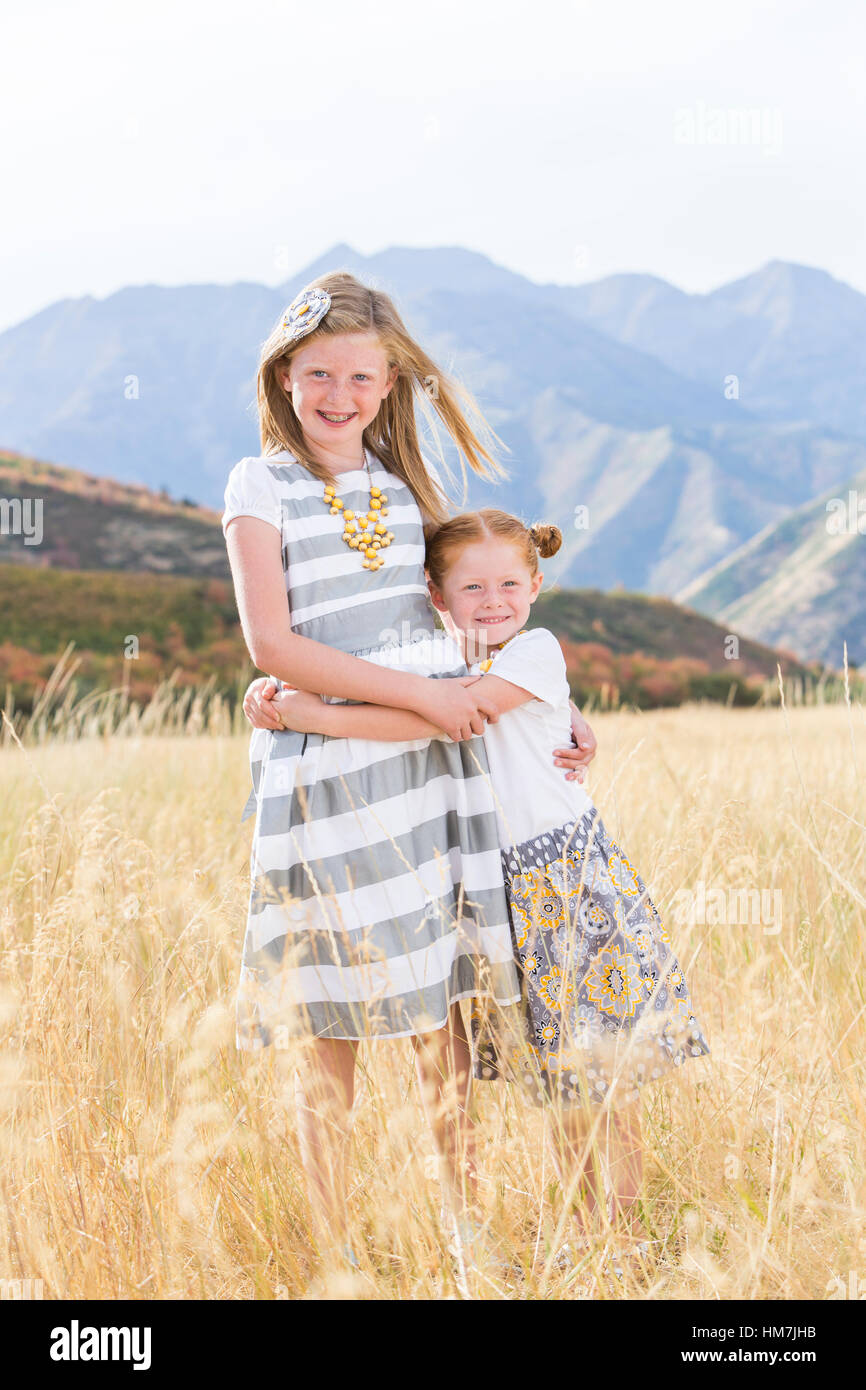 USA, Utah, Provo, Two girls (4-5, 8-9) standing in field Stock Photo