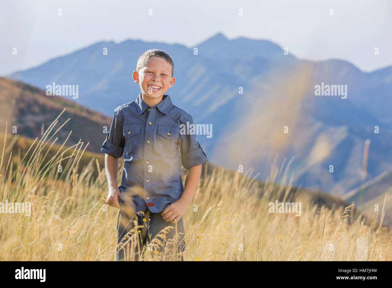 USA, Utah, Provo, Boy (6-7) standing in field Stock Photo