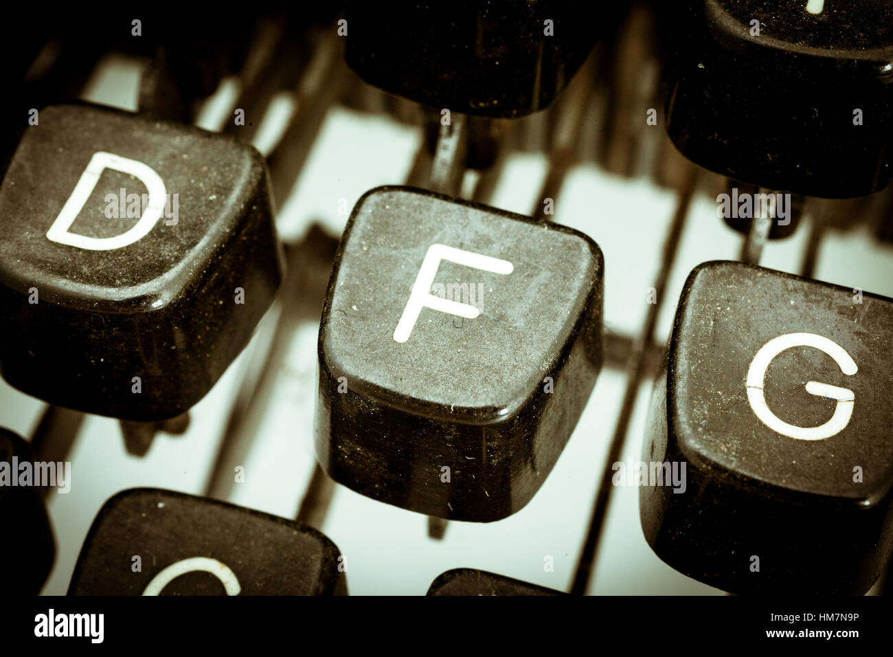 F letter closeup between other letters on an original vintage typewriter's keyboard Stock Photo
