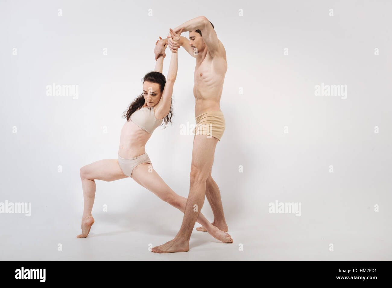 Artistic young gymnasts stretching in the studio Stock Photo