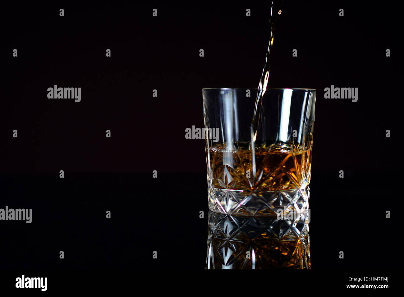 Pouring Bourbon whiskey into glass Stock Photo Alamy