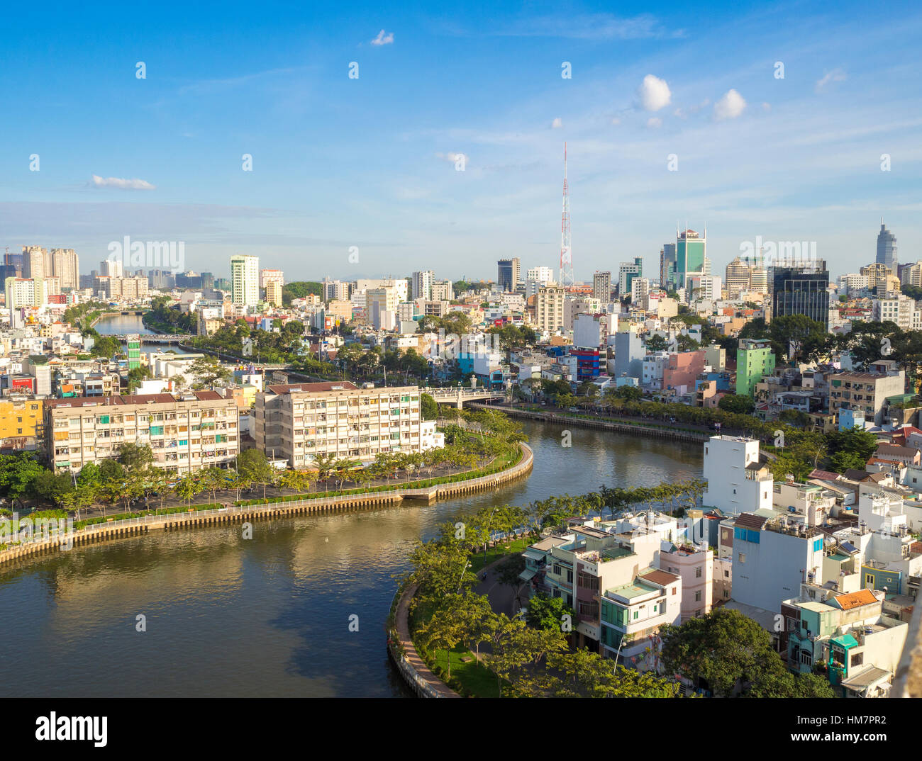 Aerial sunshine view of rooftop skyscraper on Nhieu Loc canal in Ho Chi ...