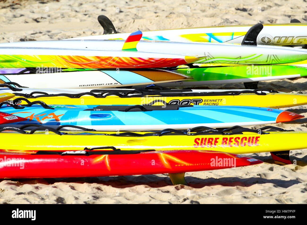 Numerous colourful surf rescue boards at Kings Beach on the Sunshine Coast of Queensland, Australia. Stock Photo