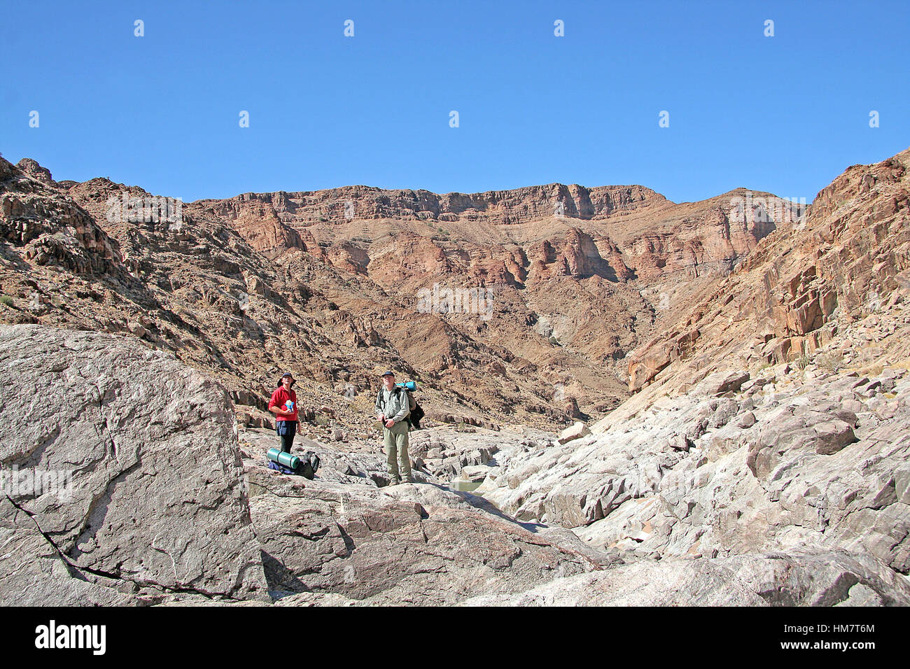 Hikers enjoying the view at the Fish River Canyon Hiking Trail a semi desert gorge in Southern  Namibia Stock Photo