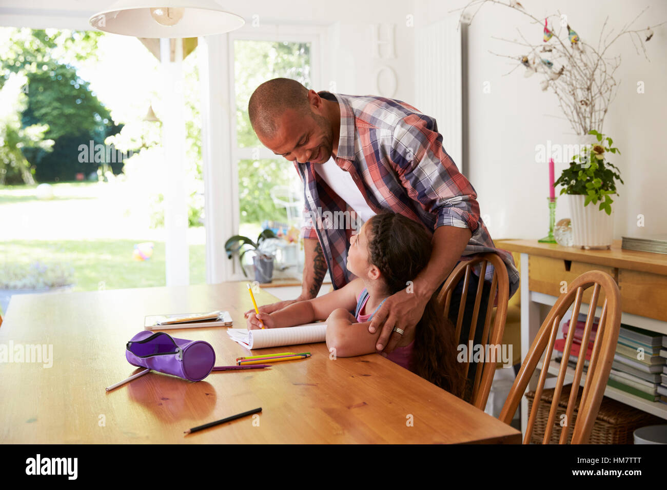 Father Helping Daughter With Homework At Table Stock Photo - Alamy