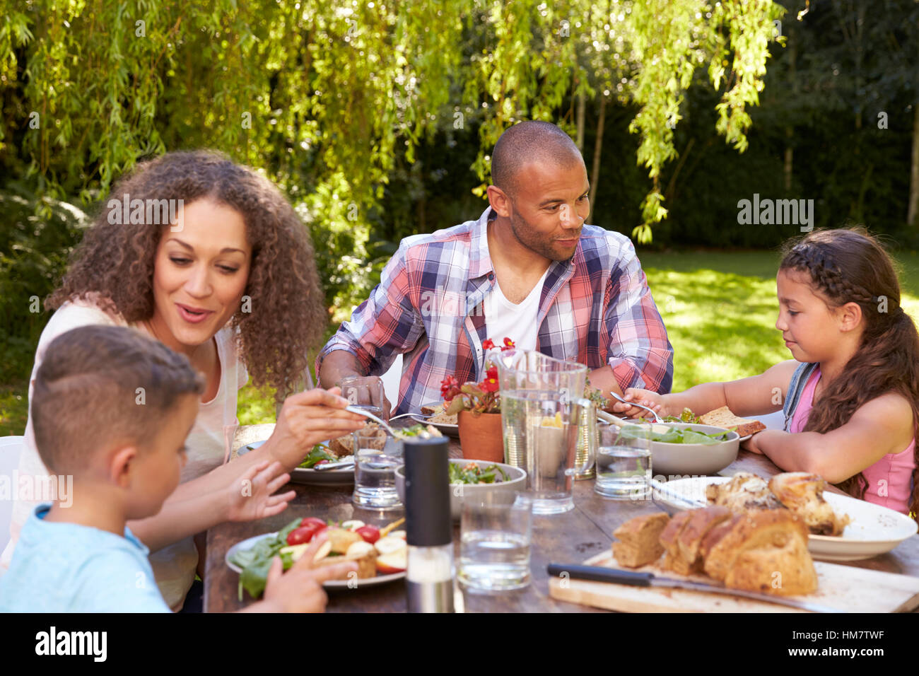 Family At Home Eating Outdoor Meal In Garden Together Stock Photo - Alamy