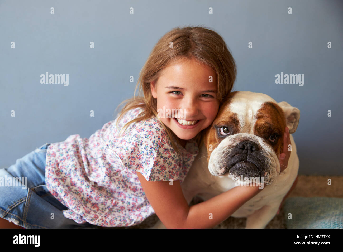 Portrait Of Smiling Girl With Pet British Bulldog Stock Photo