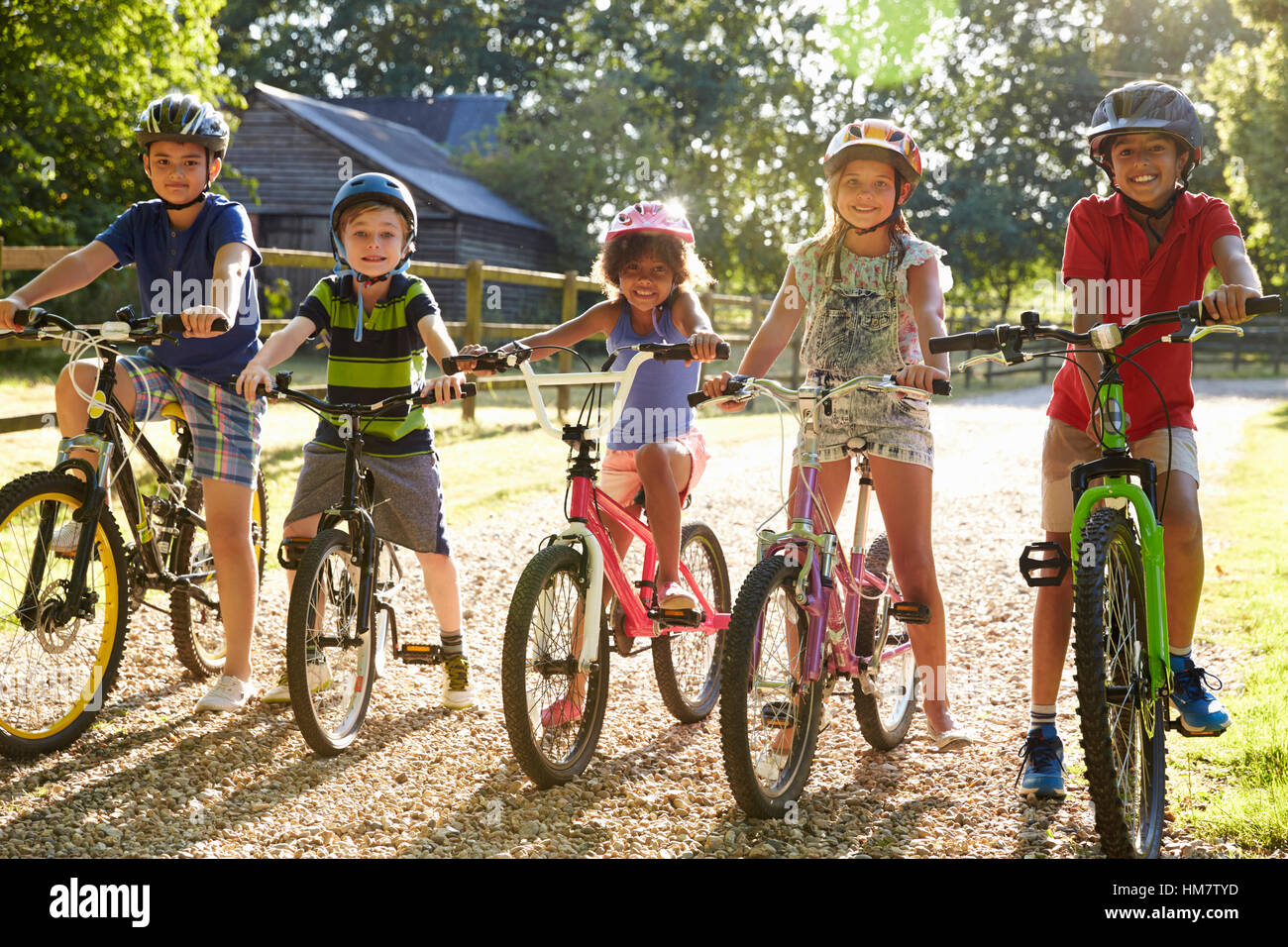 Portrait Of Five Children On Cycle Ride Together Stock Photo - Alamy