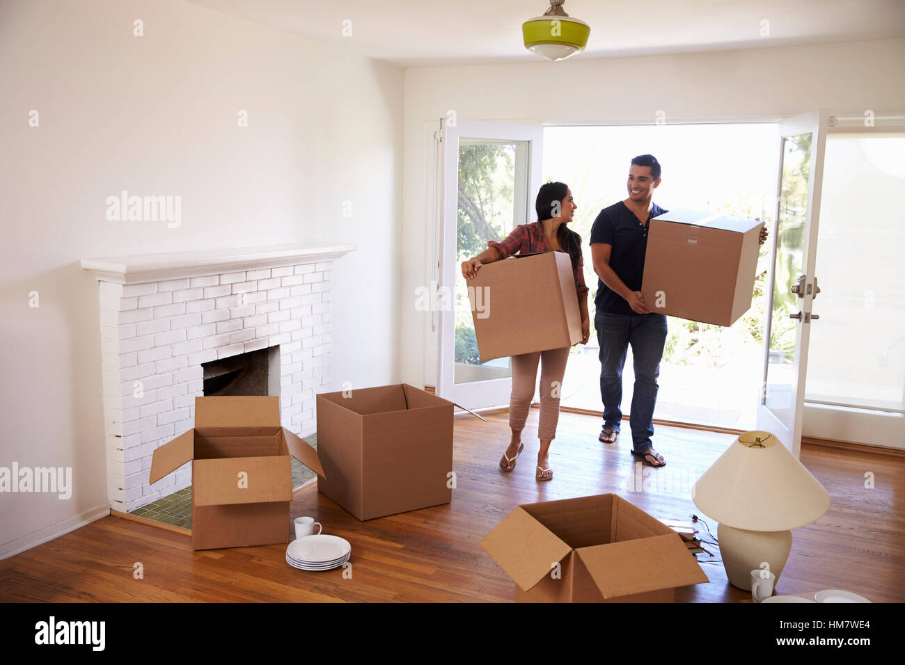Couple Carrying Boxes Into New Home On Moving Day Stock Photo - Alamy
