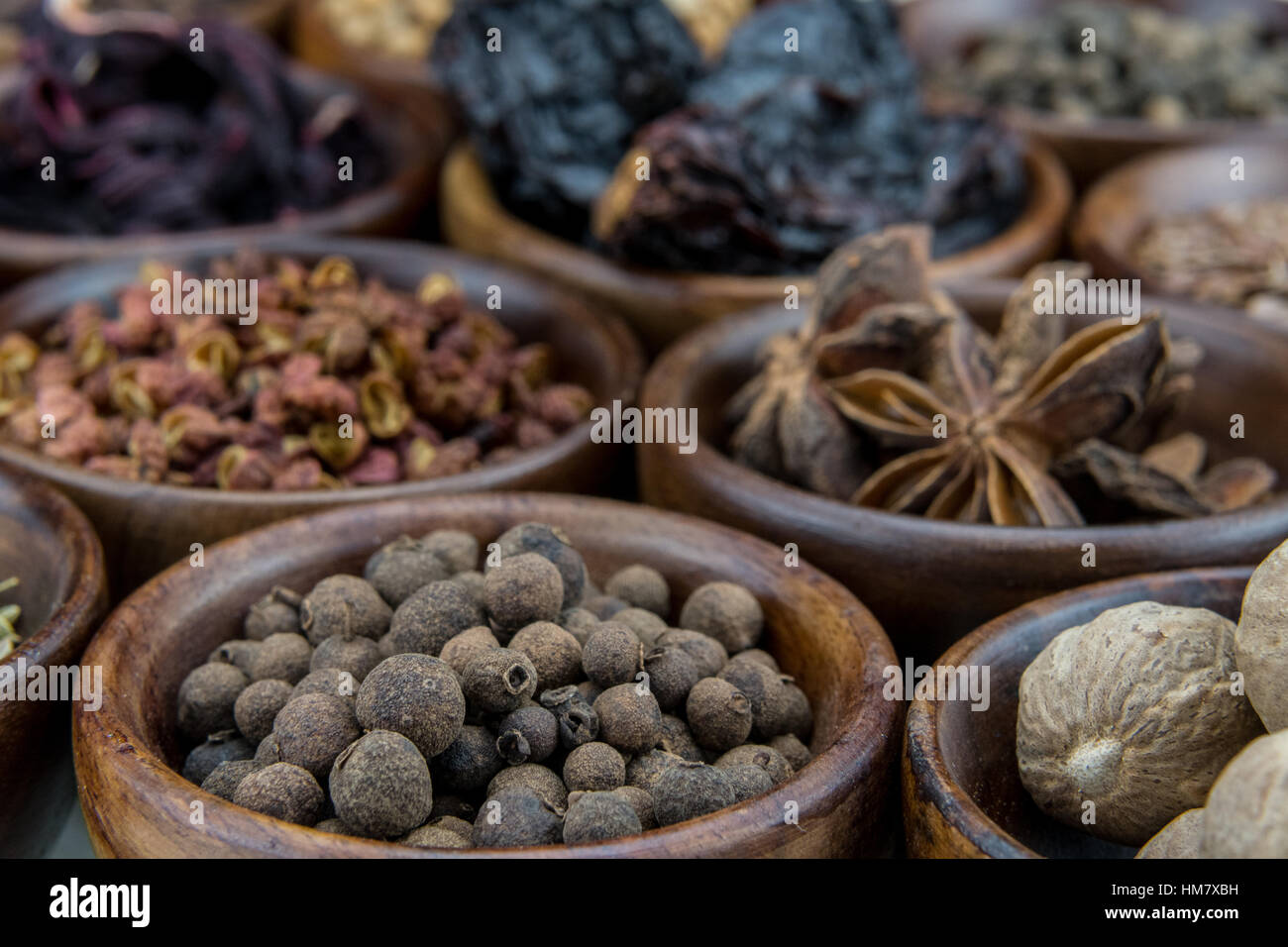 Allspice Berries Among Other Spices in small brown bowls Stock Photo