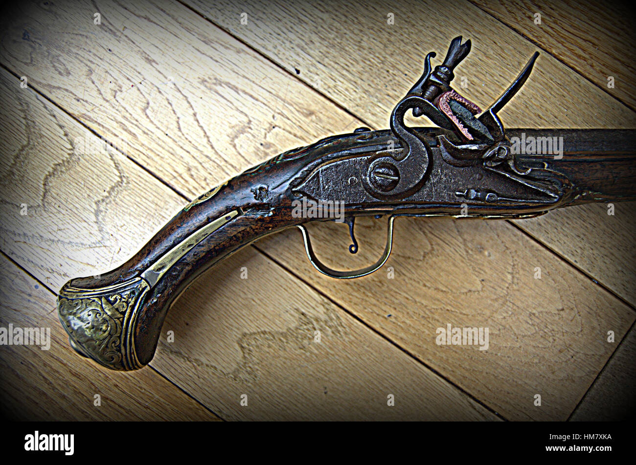 Flintlock pistol with coins. Stock Photo