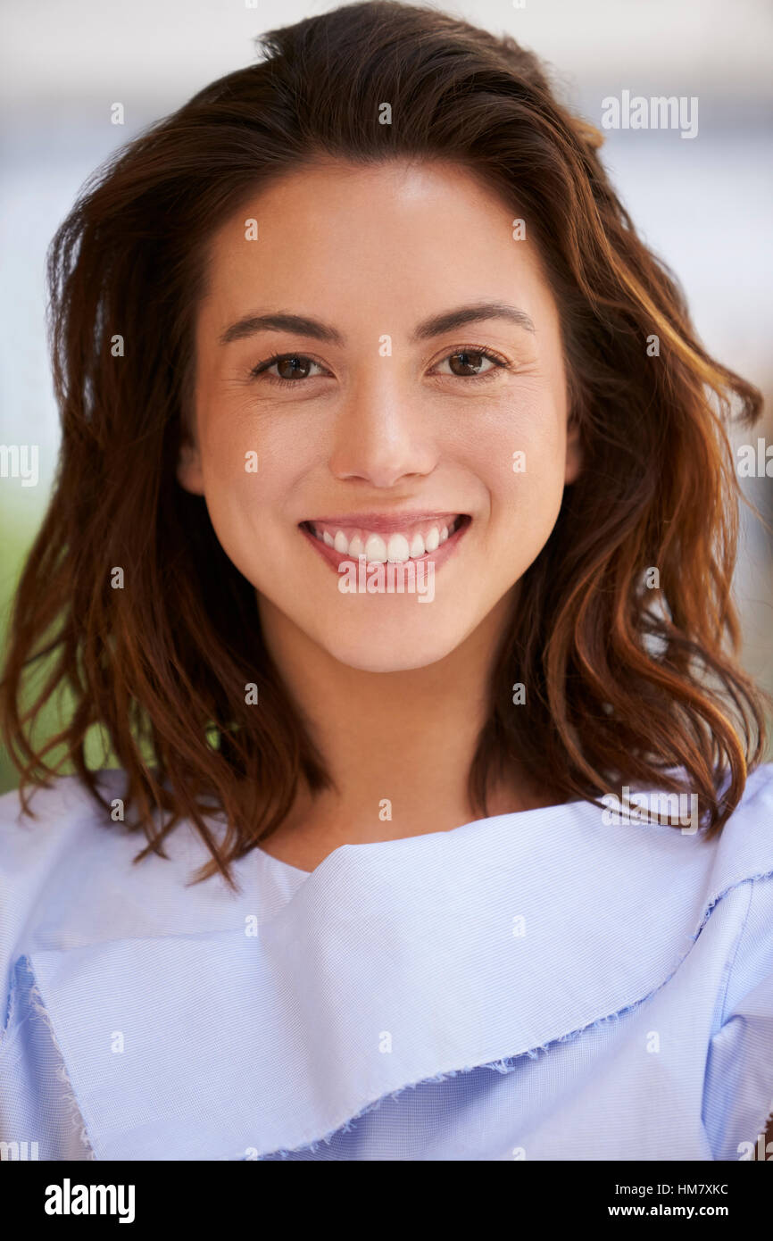 Smiling mixed race young businesswoman, vertical, close up Stock Photo