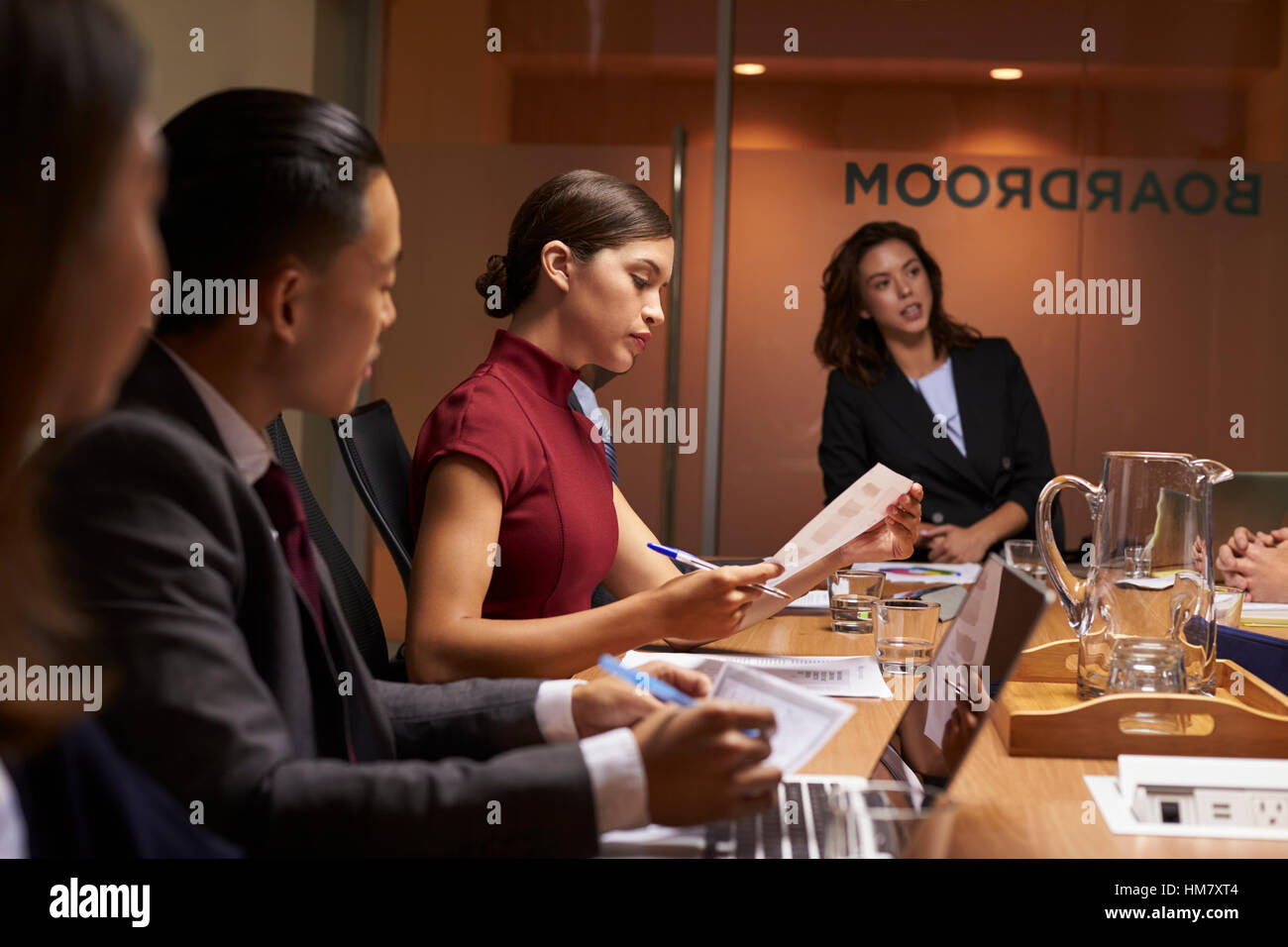 Female boss chairing business meeting in boardroom, close up Stock Photo