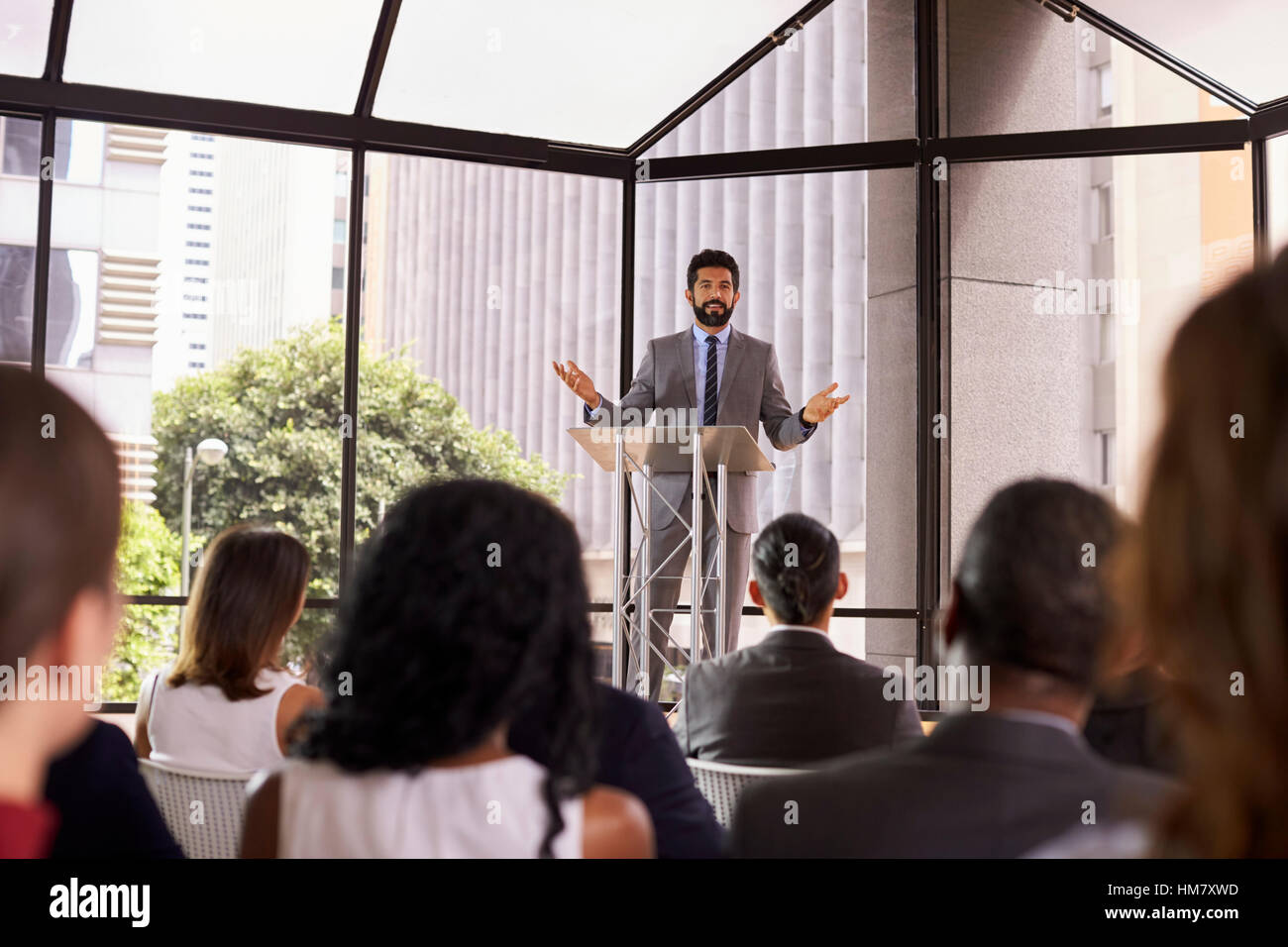 Hispanic man gesturing to audience at business seminar Stock Photo