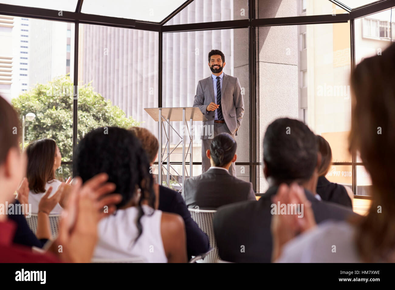 Audience applauding speaker at a business seminar Stock Photo