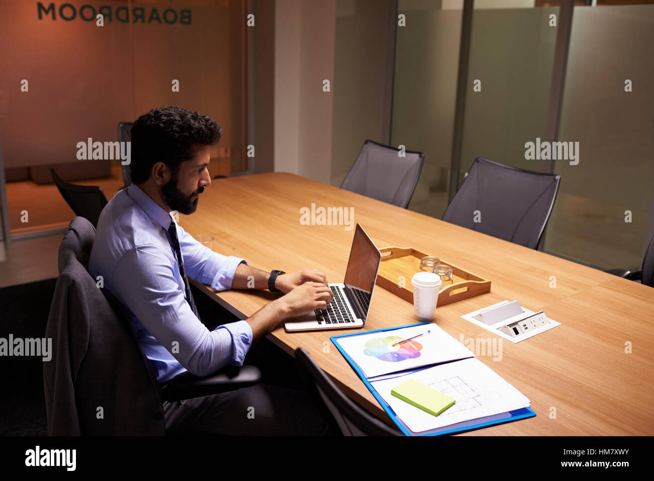 Hispanic businessman working late in office, elevated view Stock Photo