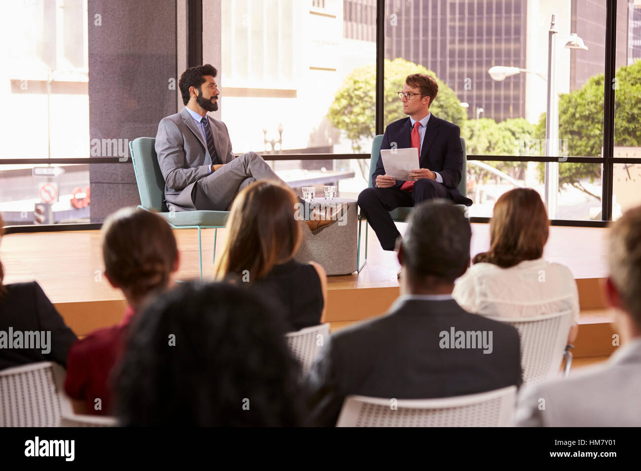 Speaker and interviewer in front of audience at a seminar Stock Photo