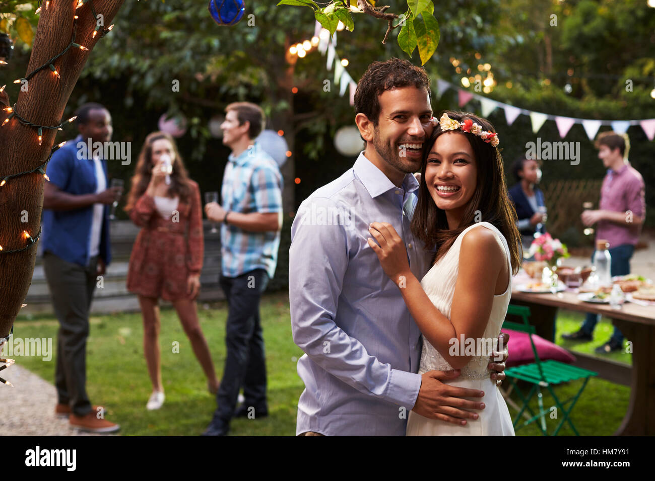 Portrait Of Couple Celebrating Wedding With Backyard Party Stock Photo