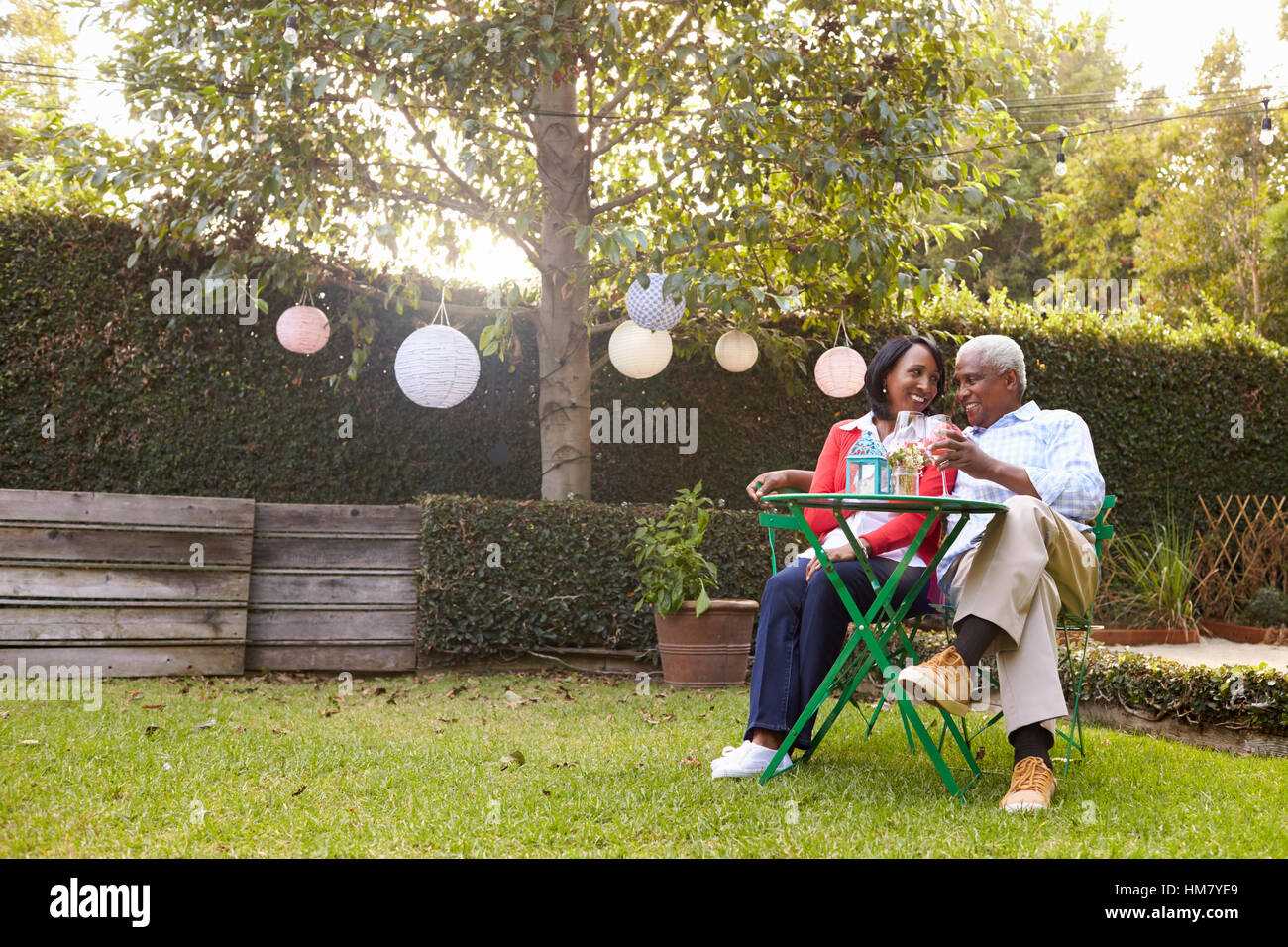Senior African American couple sitting in their back garden Stock Photo ...