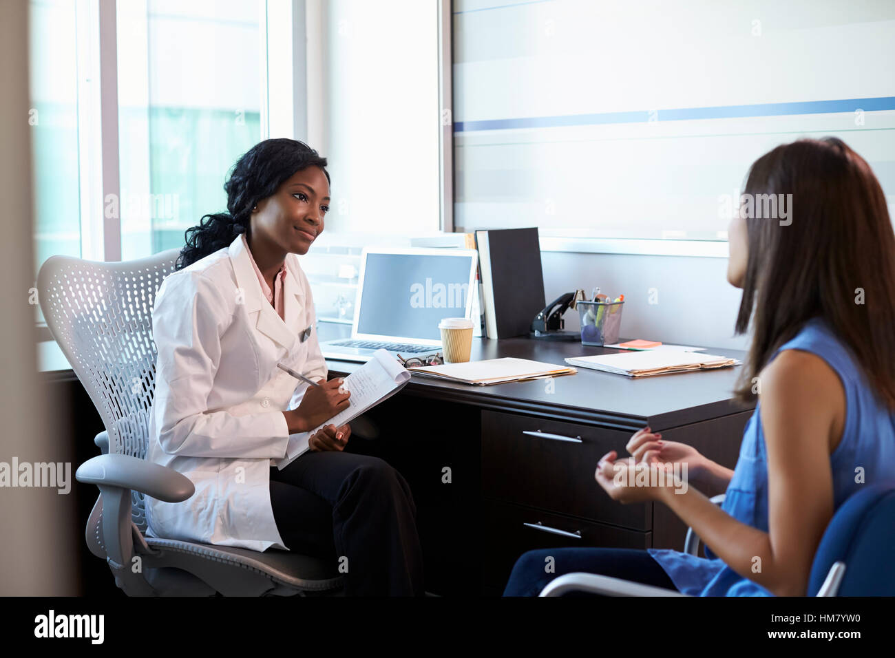 Doctor Wearing White Coat Meeting With Female Patient Stock Photo Alamy
