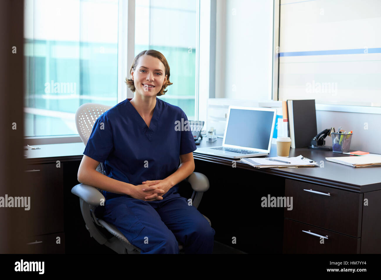 Portrait nurse wearing scrubs sitting hi-res stock photography and ...