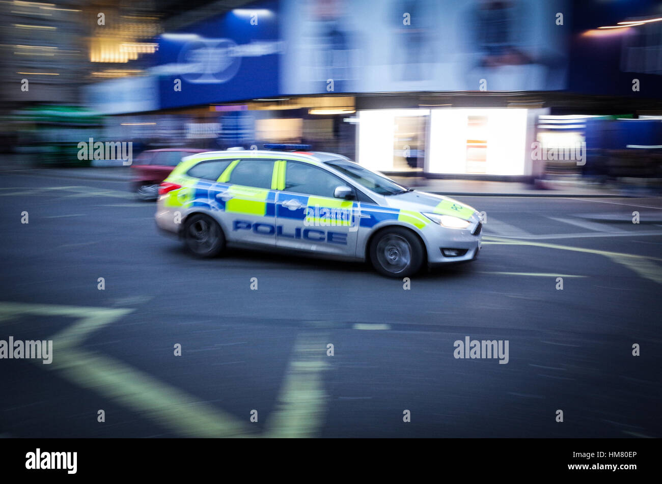A London Metropolitan police car crosses Piccadilly Circus in Central London - Motion Blur Stock Photo