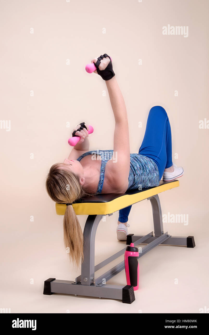 Woman on a weightlifting bench in a gym Stock Photo