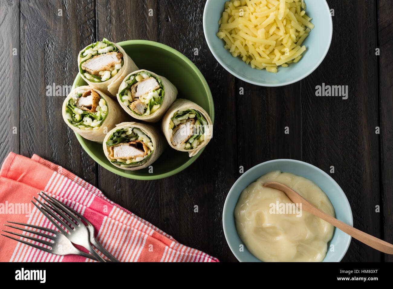 Breaded Chicken burrito Wrap With Fresh Lettuce Cheese on rustic background Stock Photo